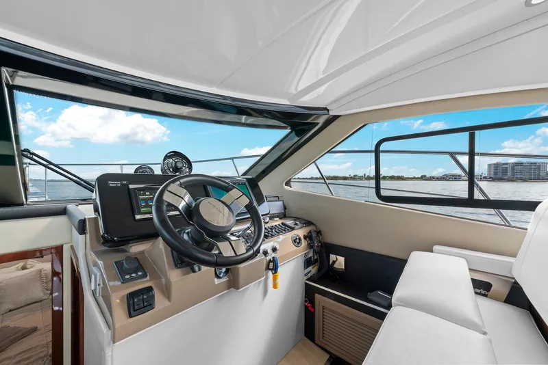 Slide: The Image of Interior of 2016 Carver C37 Coupe yacht, featuring modern helm and navigation equipment. - 39