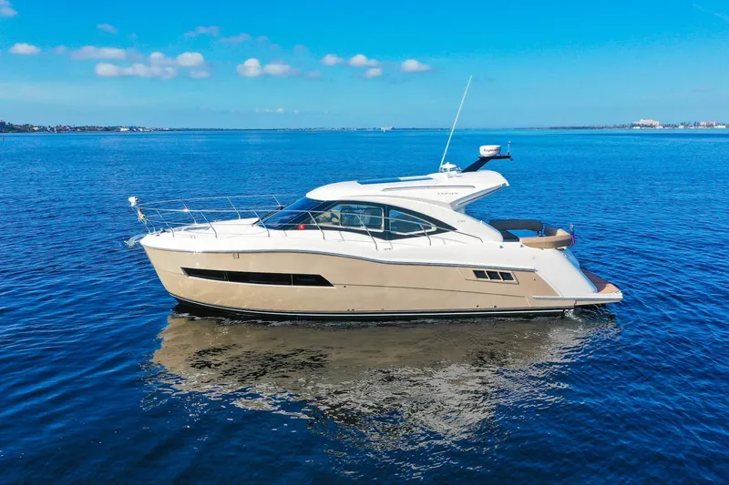 Slide: The Image of 2016 Carver C37 Coupe yacht on calm blue water under clear sky. - 4
