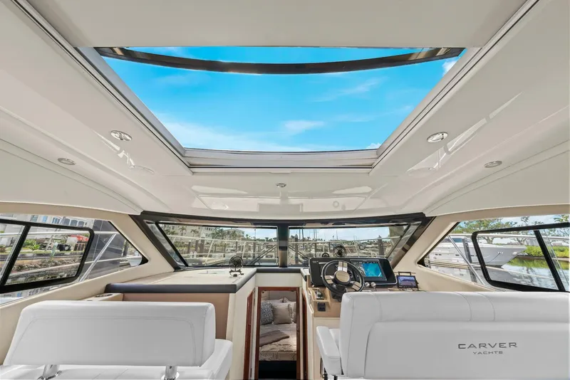 Slide: The Image of Interior of 2016 Carver C37 Coupe yacht with panoramic sunroof and modern helm. - 44