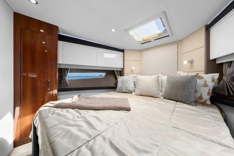 Slide: The Image of Luxurious bedroom interior of 2016 Carver C37 Coupe yacht with skylight and elegant decor. - 47