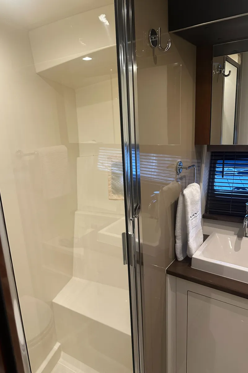 Slide: The Image of 2016 Carver C37 Coupe bathroom with glass shower and modern sink. - 52