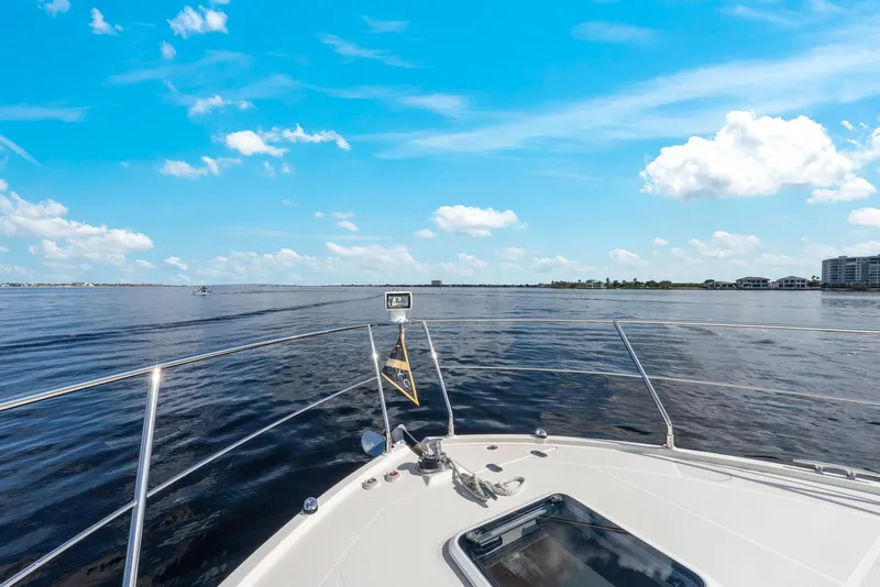 Slide: The Image of Bow view from 2016 Carver C37 Coupe on open water under blue sky. - 8