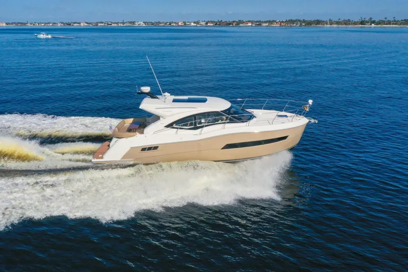Slide: The Image of 2016 Carver C37 Coupe yacht cruising on open water. - 0
