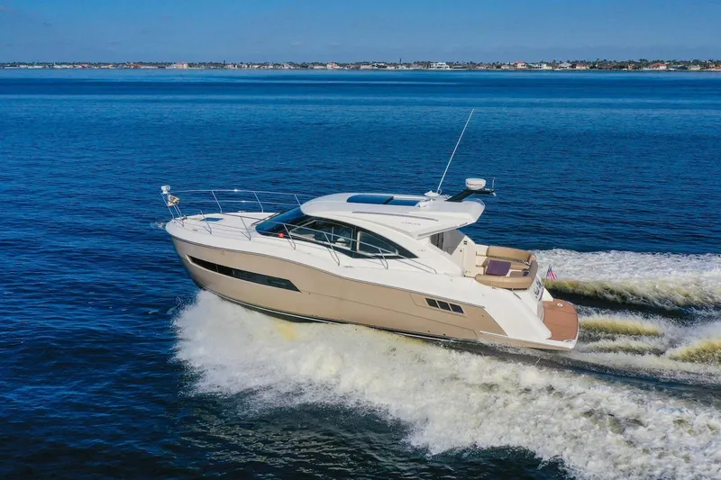Slide: The Image of 2016 Carver C37 Coupe yacht cruising on open water. - 1