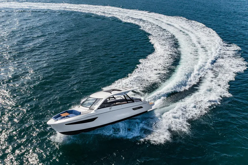 Slide: The Image of 2023 Bavaria Vida 33 yacht cruising on open water, creating a dynamic wake. - 13
