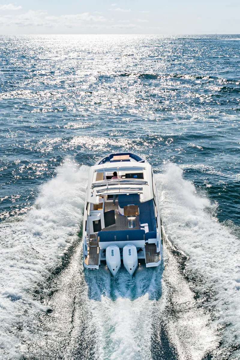 Slide: The Image of 2023 Bavaria Vida 33 yacht cruising on open sea, creating waves. - 19