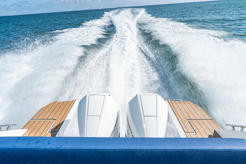 Slide: The Image of 2023 Bavaria Vida 33 yacht speeding on open water, leaving a foamy wake. - 35