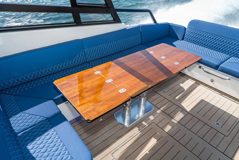 Slide: The Image of Luxurious Bavaria Vida 33 yacht interior with blue seating and wooden table, 2023 model. - 37