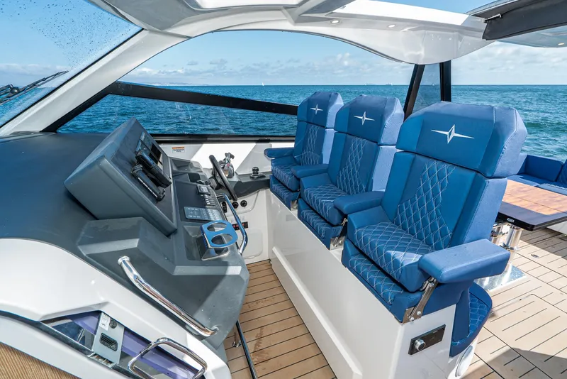 Slide: The Image of Luxurious 2023 Bavaria Vida 33 yacht interior with blue seating and modern controls. - 45