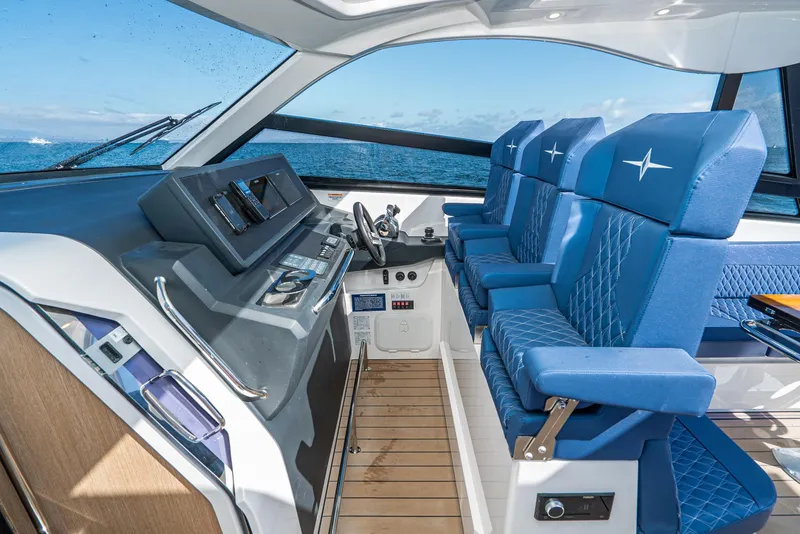 Slide: The Image of Interior of 2023 Bavaria Vida 33 yacht with blue seating and modern dashboard. - 46
