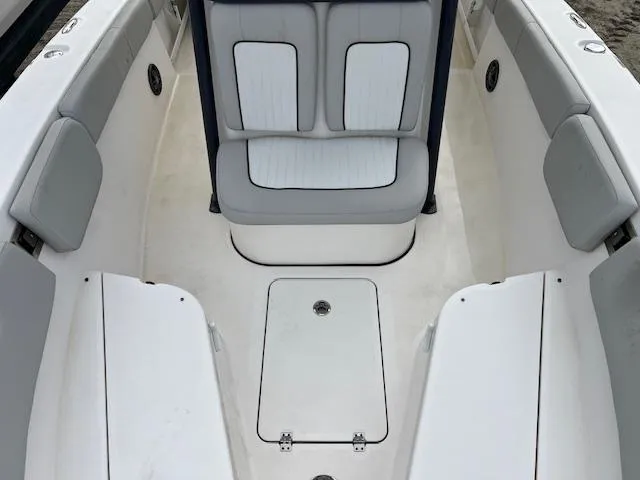 Slide: The Image of 2021 Sea Fox 248 Commander boat interior with cushioned seating and storage compartments. - 9