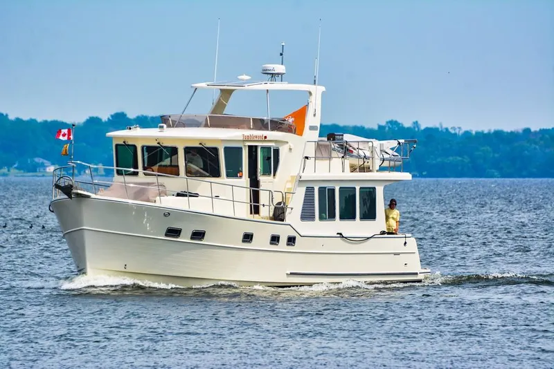 Slide: The Image of 2016 North Pacific 49 Pilothouse yacht cruising on a calm lake. - 0