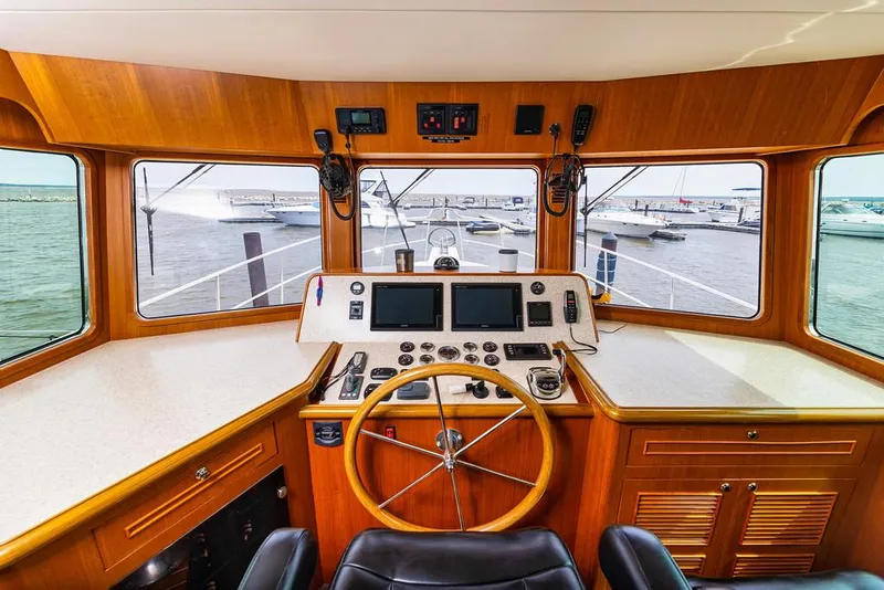 Slide: The Image of Interior view of 2016 North Pacific 49 Pilothouse helm with navigation equipment. - 15