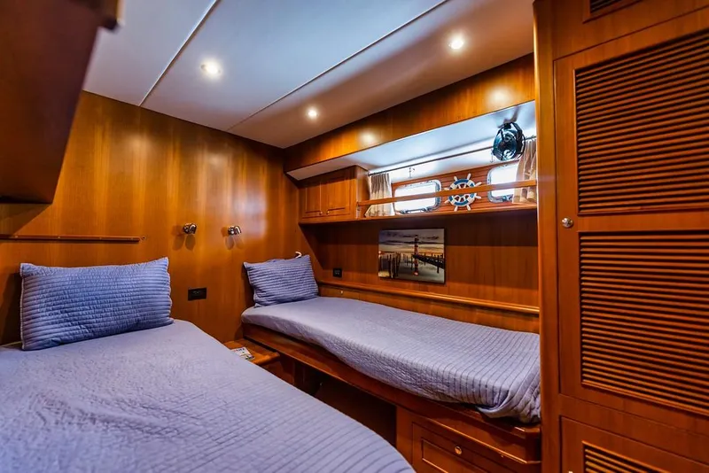 Slide: The Image of Luxurious 2016 North Pacific 49 Pilothouse cabin with twin beds and wooden interior. - 20