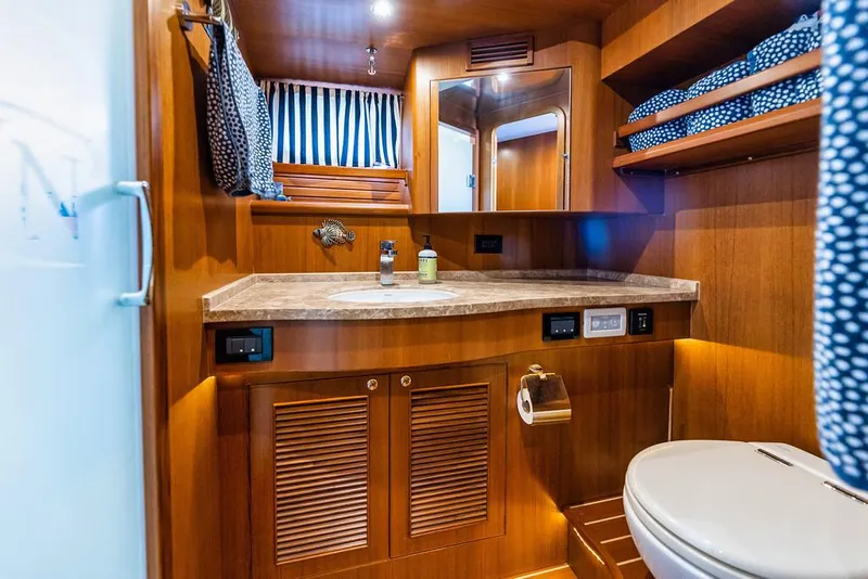 Slide: The Image of Luxurious bathroom in 2016 North Pacific 49 Pilothouse yacht with wood accents and modern amenities. - 22