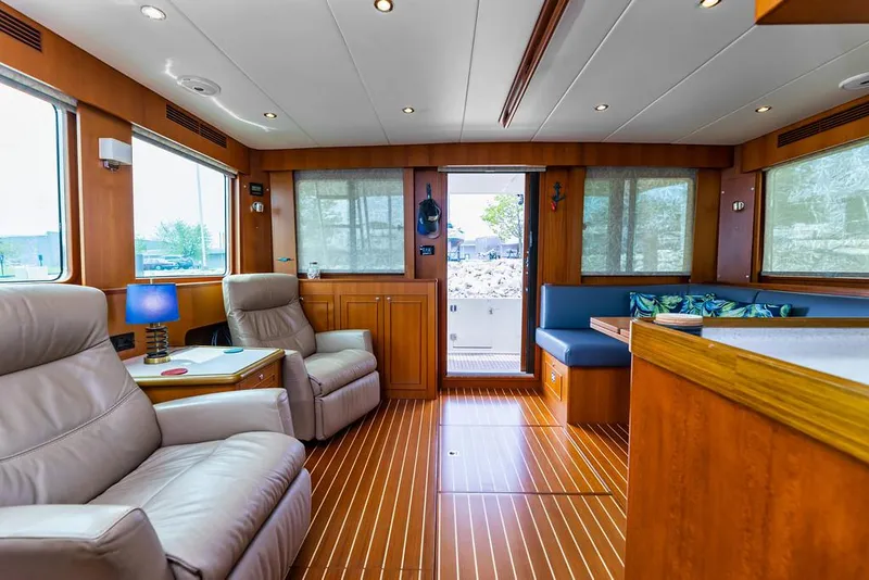 Slide: The Image of Interior of 2016 North Pacific 49 Pilothouse with wood flooring and comfortable seating. - 3