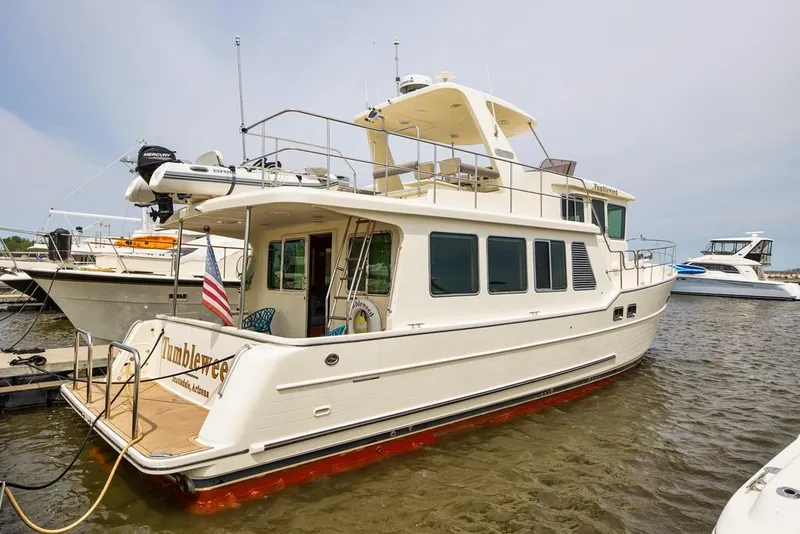 Slide: The Image of 2016 North Pacific 49 Pilothouse yacht docked at marina, side view. - 39