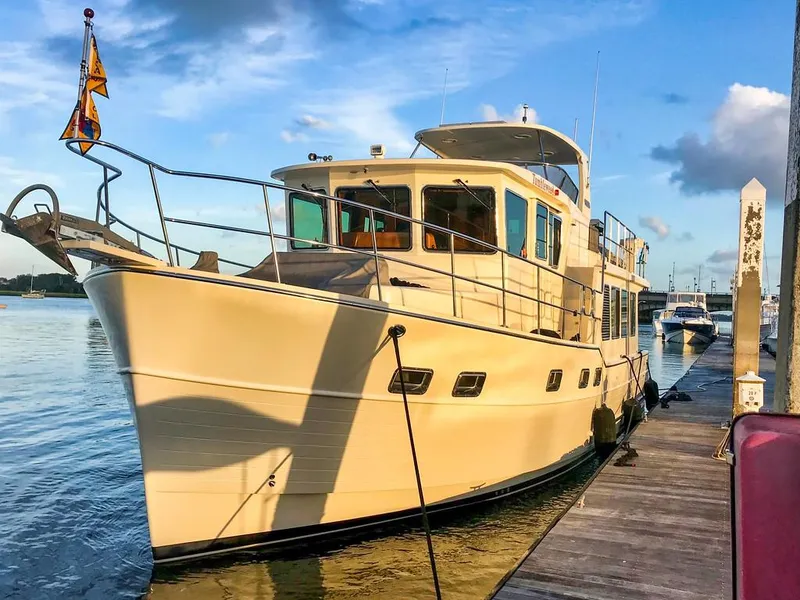 Slide: The Image of 2016 North Pacific 49 Pilothouse yacht docked at marina during sunset. - 43