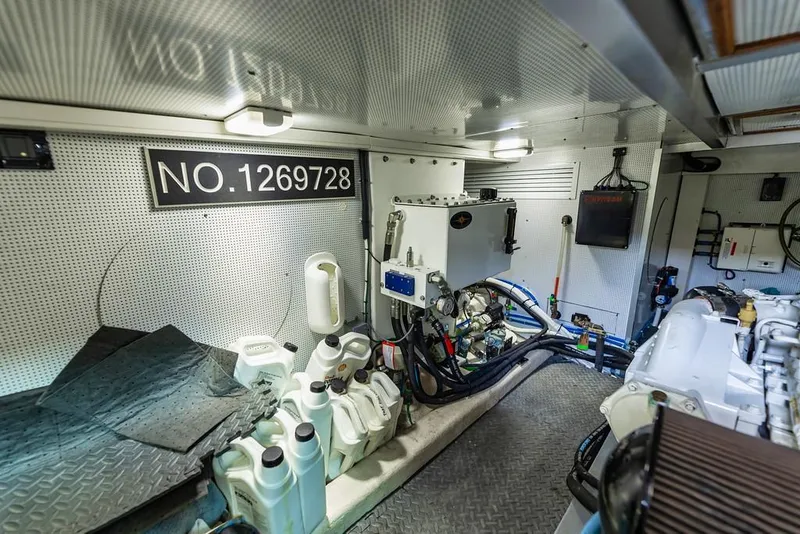 Slide: The Image of Engine room of 2016 North Pacific 49 Pilothouse with equipment and storage containers. - 46