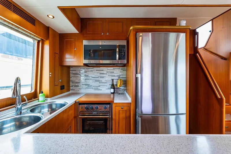 Slide: The Image of Modern kitchen in a 2016 North Pacific 49 Pilothouse yacht with stainless steel appliances. - 6