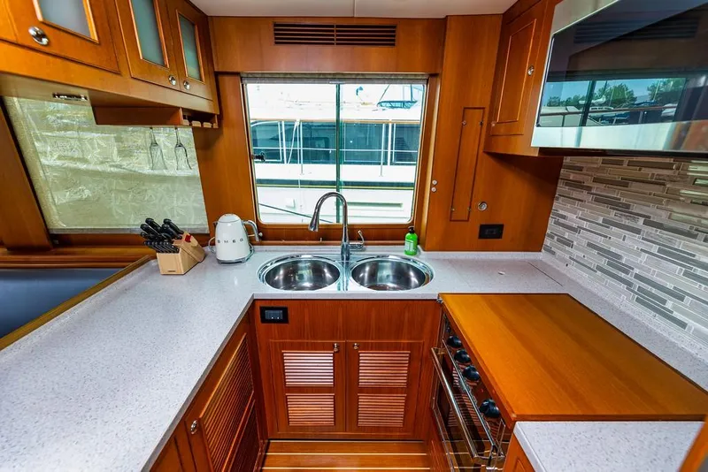 Slide: The Image of Luxurious kitchen interior of 2016 North Pacific 49 Pilothouse yacht with modern amenities. - 7