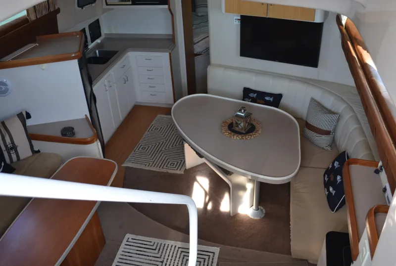 Slide: The Image of Interior of 1995 Mainship 37 Motor Yacht with dining area and kitchenette. - 10