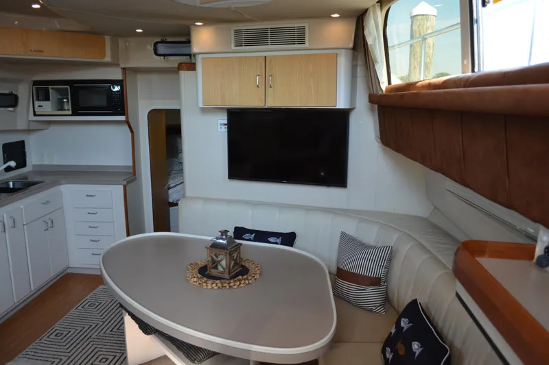 Slide: The Image of Interior of 1995 Mainship 37 Motor Yacht with modern kitchen and cozy seating area. - 11