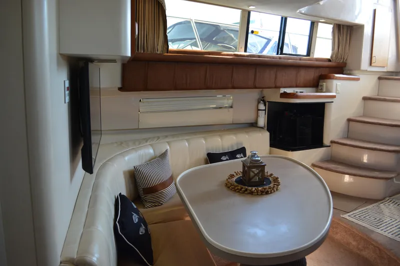 Slide: The Image of Interior of 1995 Mainship 37 Motor Yacht with cozy seating and table. - 14
