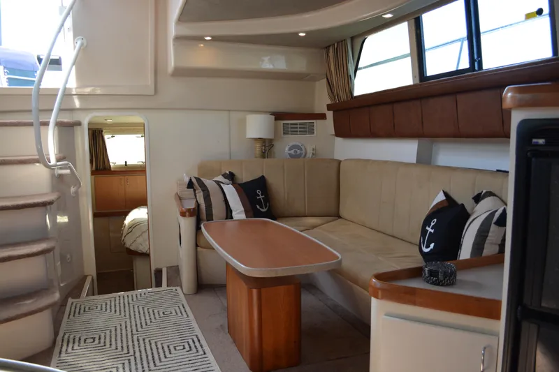 Slide: The Image of Luxurious interior of 1995 Mainship 37 Motor Yacht with cozy seating and nautical decor. - 16
