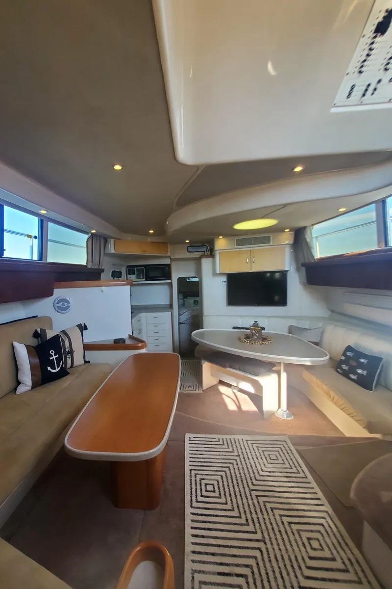 Slide: The Image of Interior of 1995 Mainship 37 Motor Yacht with cozy seating and nautical decor. - 17