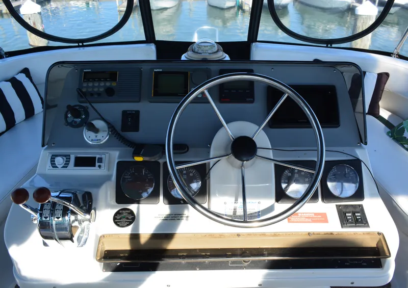 Slide: The Image of 1995 Mainship 37 Motor Yacht helm with steering wheel and control panel. - 9