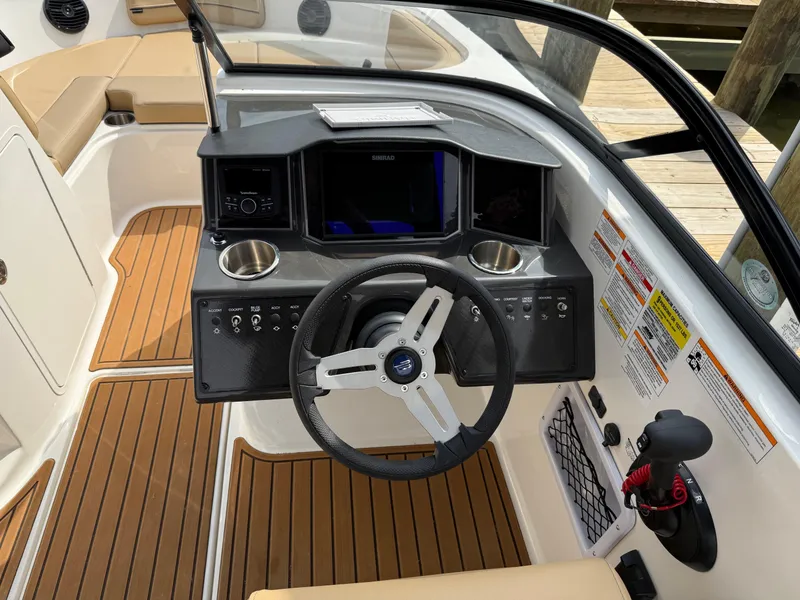 Slide: The Image of 2025 Bayliner VR5 Bowrider OB dashboard with steering wheel and controls. - 11
