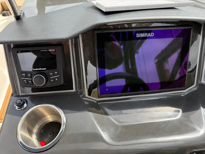 Slide: The Image of 2025 Bayliner VR5 Bowrider OB dashboard with Simrad display and Rockford Fosgate audio system. - 12
