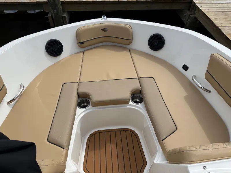 Slide: The Image of 2025 Bayliner VR5 Bowrider OB boat with tan seating and wood accents. - 14