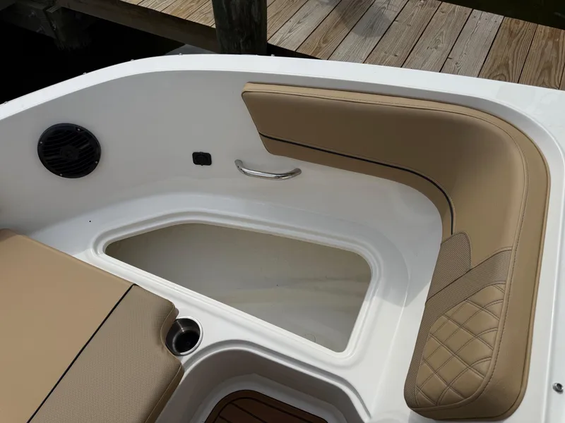Slide: The Image of 2025 Bayliner VR5 Bowrider OB interior with tan seating and storage compartment. - 16