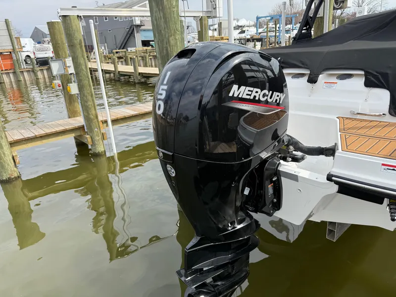 Slide: The Image of 2025 Bayliner VR5 Bowrider OB with Mercury 150 outboard motor docked at marina. - 3