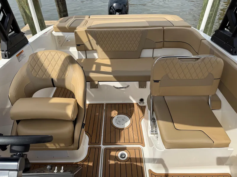 Slide: The Image of 2025 Bayliner VR5 Bowrider OB interior with tan seating and wood flooring. - 5