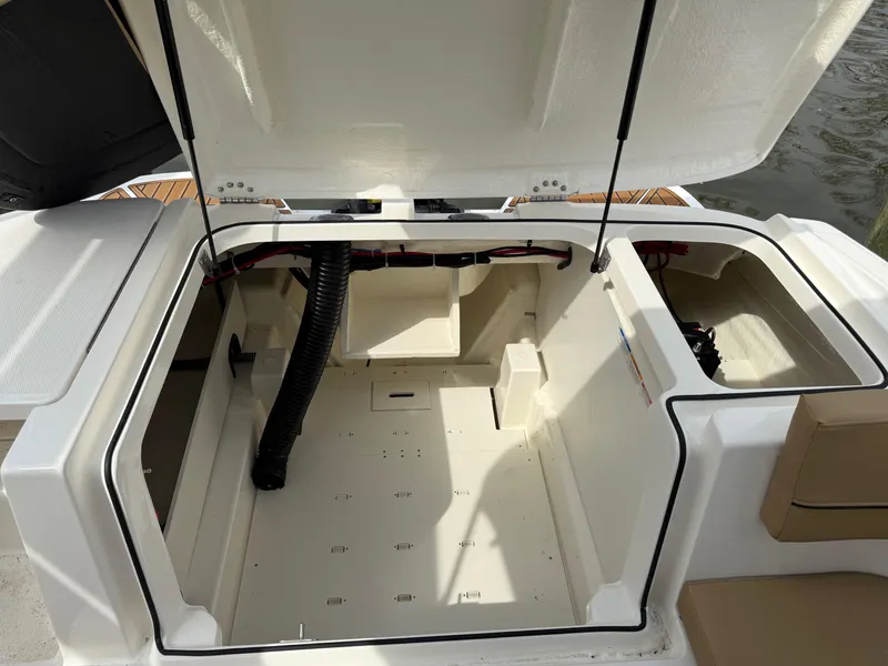 Slide: The Image of 2025 Bayliner VR5 Bowrider OB storage compartment with open hatch, showcasing spacious interior design. - 6