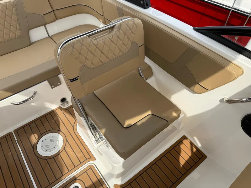 Slide: The Image of 2025 Bayliner VR5 Bowrider OB interior with tan seating and wood accents. - 7
