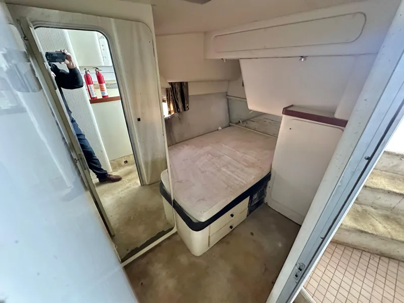 Slide: The Image of Interior cabin of 1990 Trojan 46 Flybridge yacht with bed and mirror. - 13