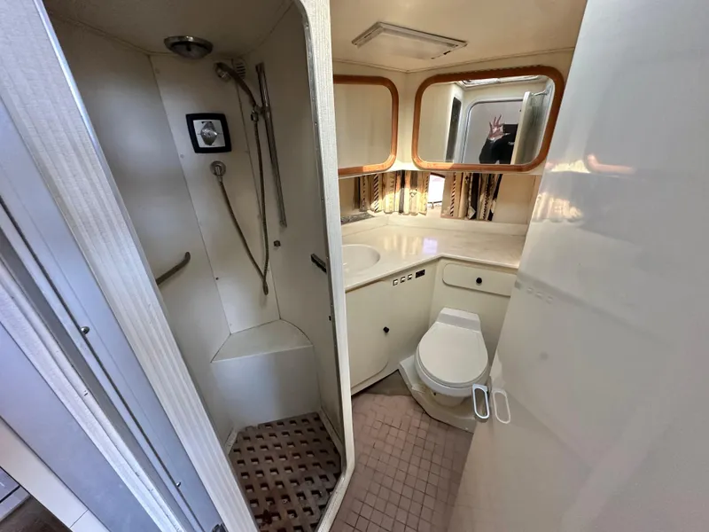 Slide: The Image of Bathroom interior of 1990 Trojan 46 Flybridge yacht with shower and toilet. - 14