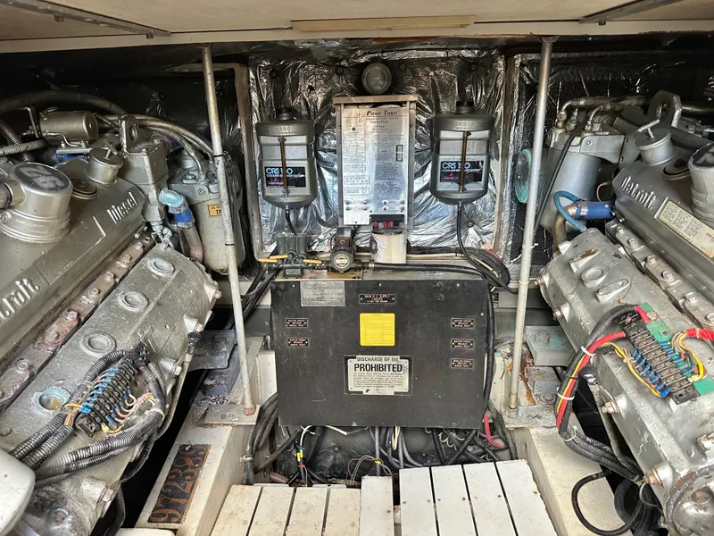 Slide: The Image of Engine room of a 1990 Trojan 46 Flybridge yacht, showcasing dual engines and control systems. - 21