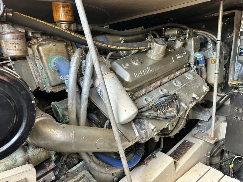 Slide: The Image of Engine compartment of a 1990 Trojan 46 Flybridge boat, showcasing mechanical components. - 22
