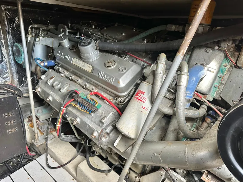 Slide: The Image of Engine compartment of a 1990 Trojan 46 Flybridge boat, featuring a diesel engine. - 23