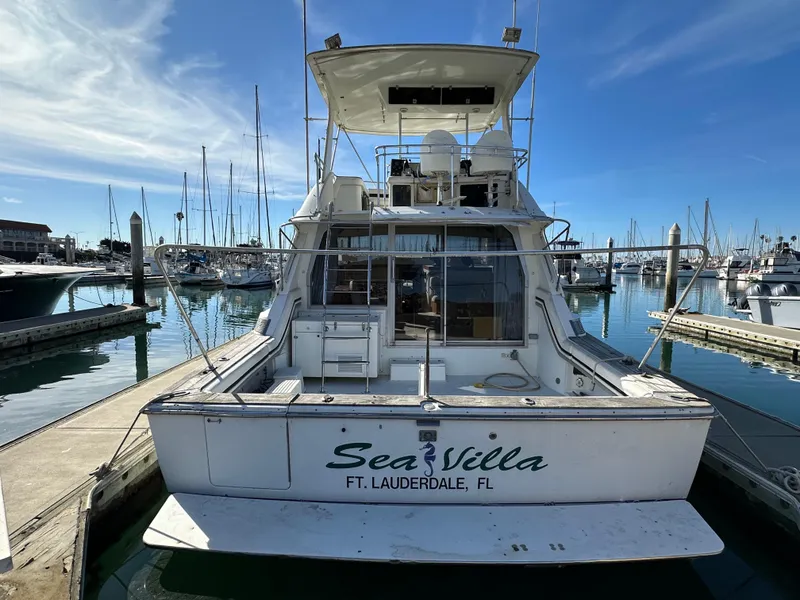 Slide: The Image of 1990 Trojan 46 Flybridge yacht docked in marina, labeled "Sea Villa," Ft. Lauderdale, FL. - 36