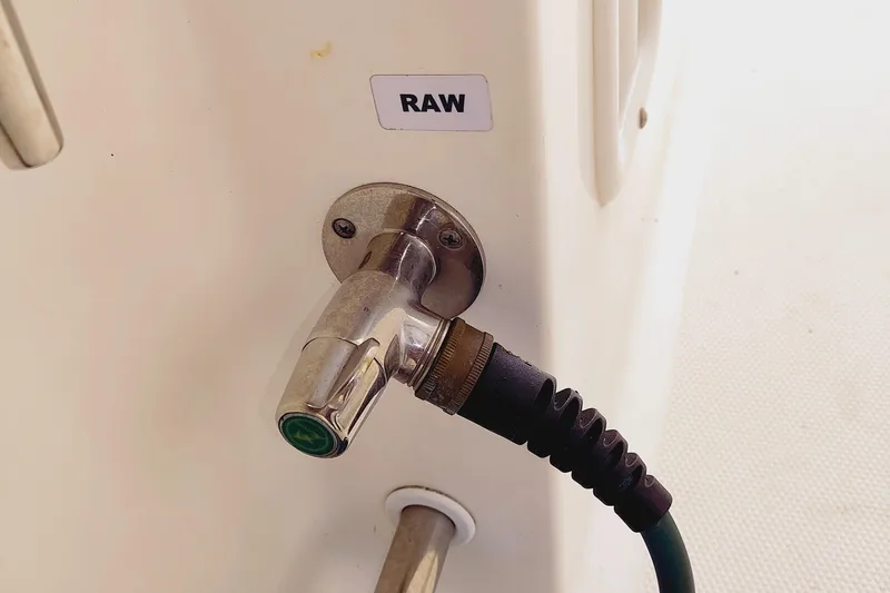 Slide: The Image of Water hose connection labeled "RAW" on 2014 Edgewater 280CC boat. - 15