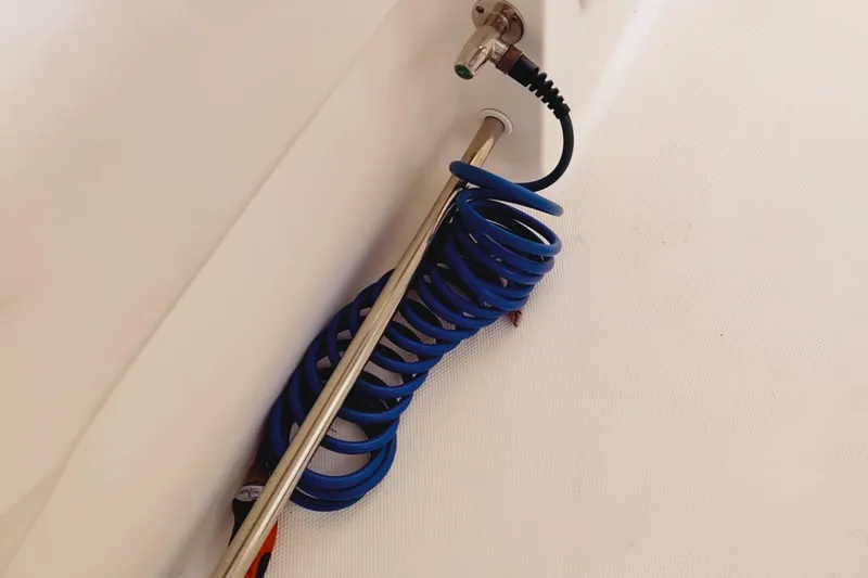 Slide: The Image of Coiled blue hose on 2014 Edgewater 280CC boat deck. - 21