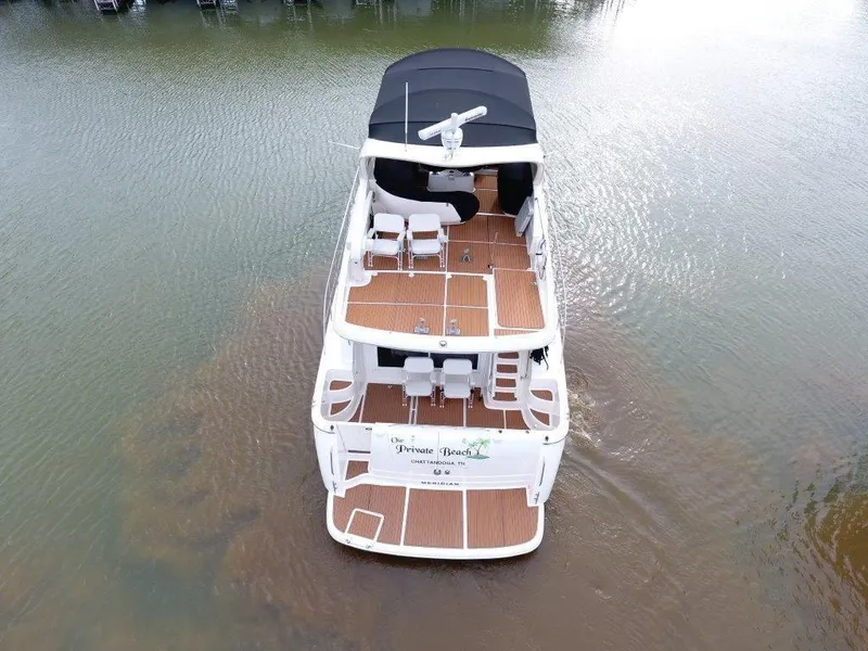 Slide: The Image of 2004 Meridian 540 Pilothouse yacht with spacious deck, docked on calm water. - 2
