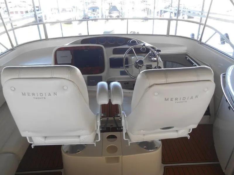 Slide: The Image of 2004 Meridian 540 Pilothouse yacht interior with steering wheel and control panel. - 4