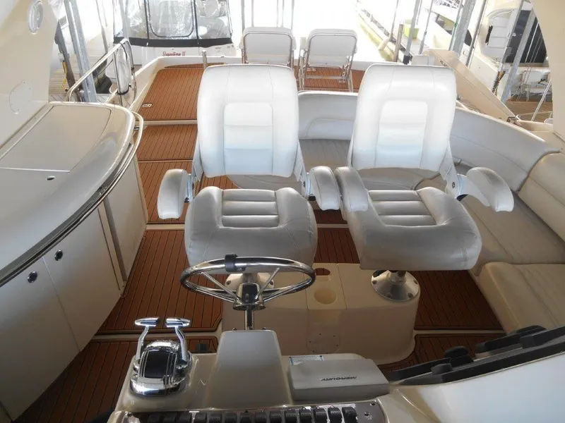 Slide: The Image of 2004 Meridian 540 Pilothouse interior with white leather seating and wooden flooring. - 5